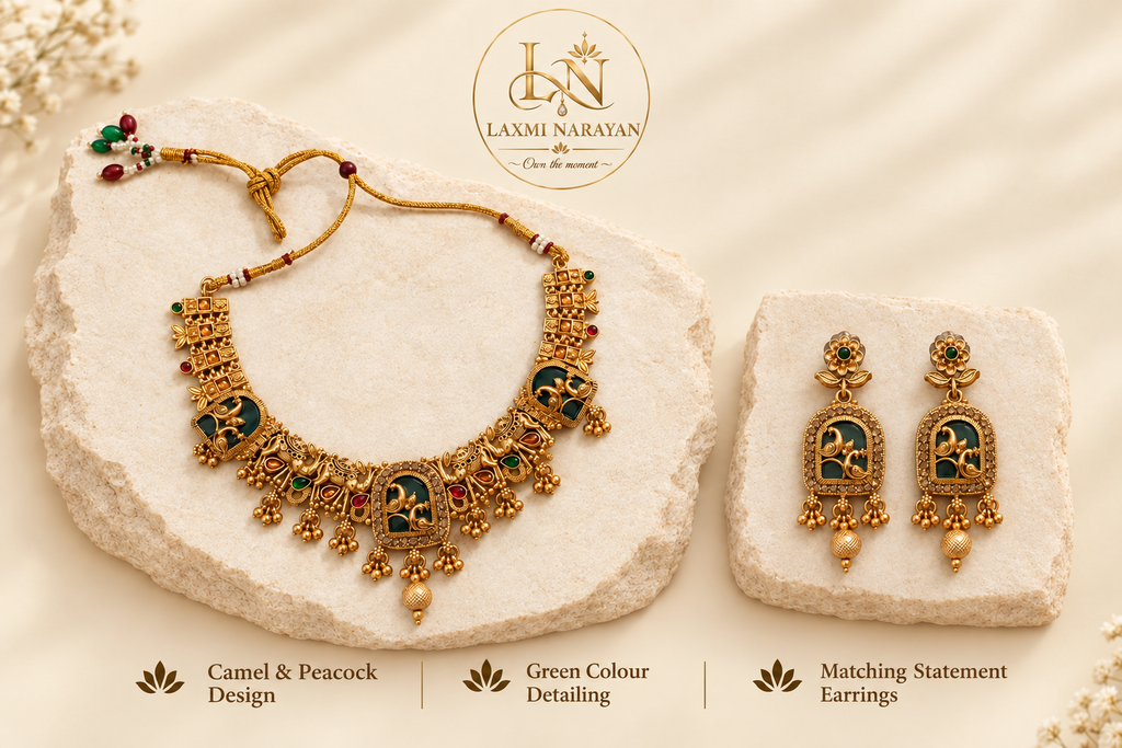 Green necklace and matching earrings on separate cream stone slabs
